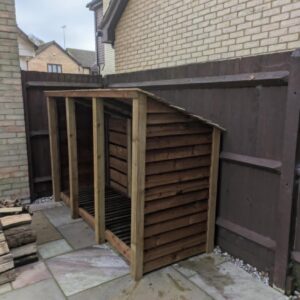 8ft x 7ft wooden log store with slanted roof and open front for firewood.