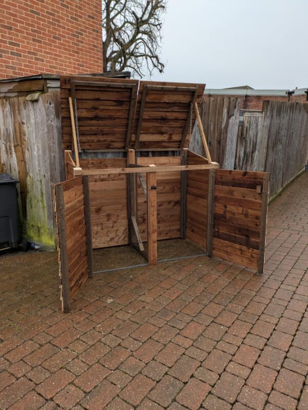 Double wheelie bin storage, brown, open doors and lids.