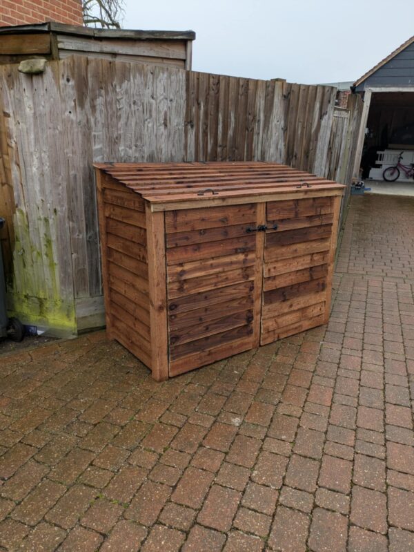 Double wheelie bin storage, brown, closed doors and lids.